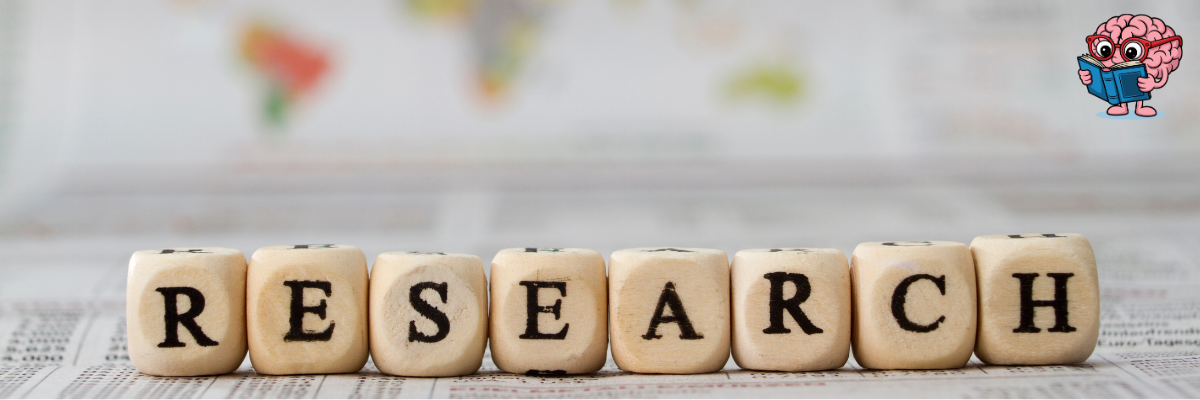 Wooden letter tiles spelling “Research” on a world-map backdrop.