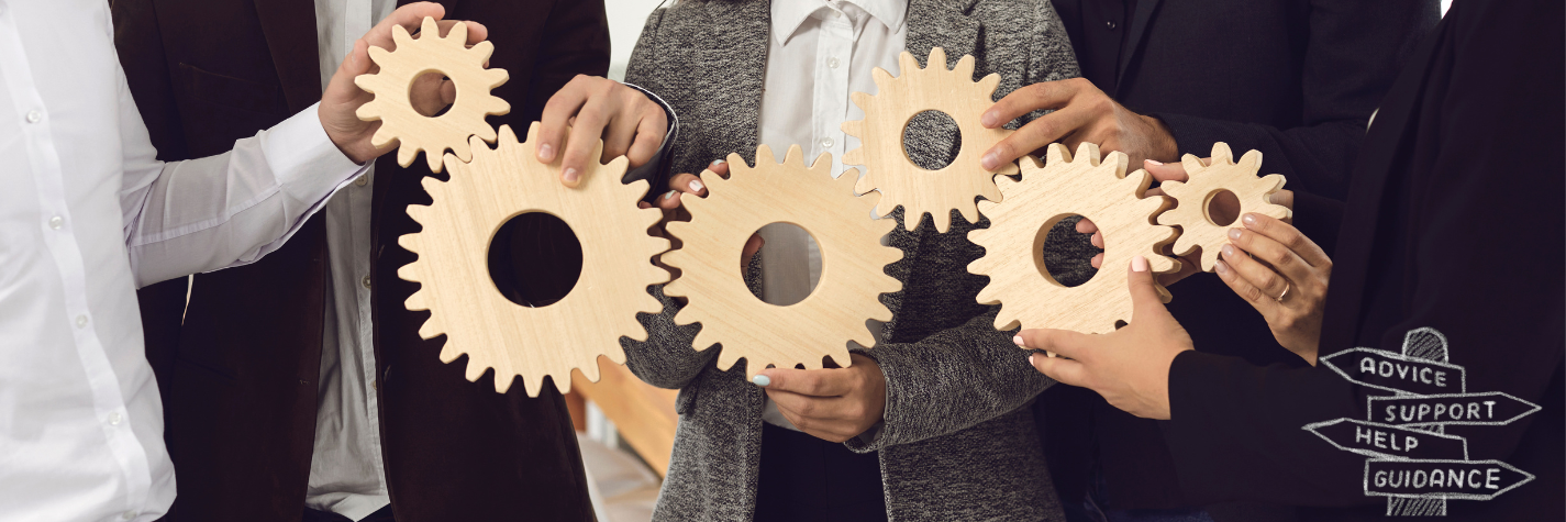 A team holding interlocking wooden gears together, representing collaboration and support.